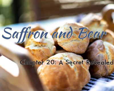 A background image of biscuits is overlaid with the text "Saffron and Bear" and "Chapter 20: A Secret Revealed"